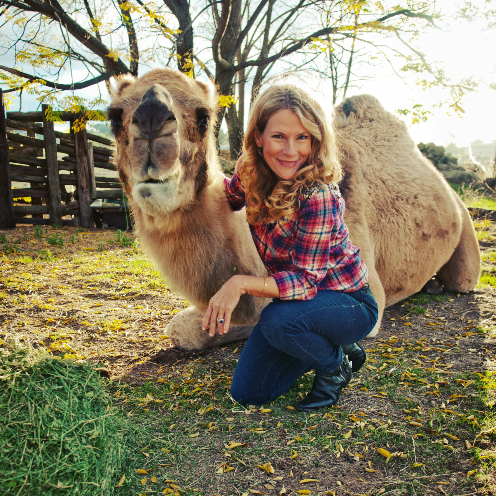 Christina Adams posing with a camel on the ground